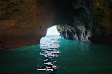 a cave next to a body of water