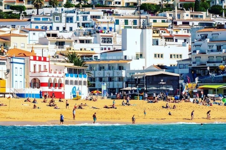 a group of people sitting at a crowded beach