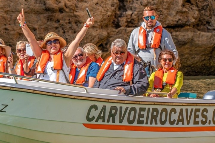 a group of people riding on the back of a boat
