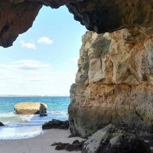 a rocky island in the middle of a body of water