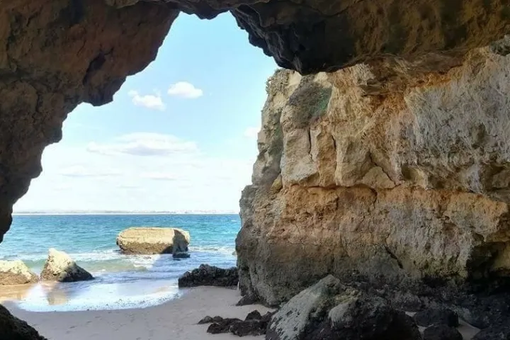 a rocky island in the middle of a body of water