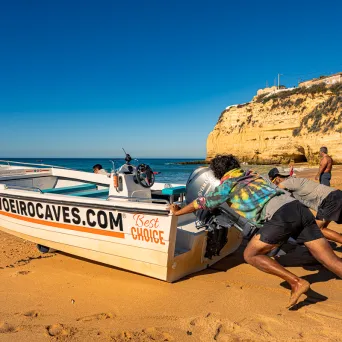 a group of people sitting at a beach