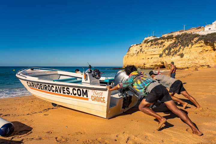 a group of people sitting at a beach
